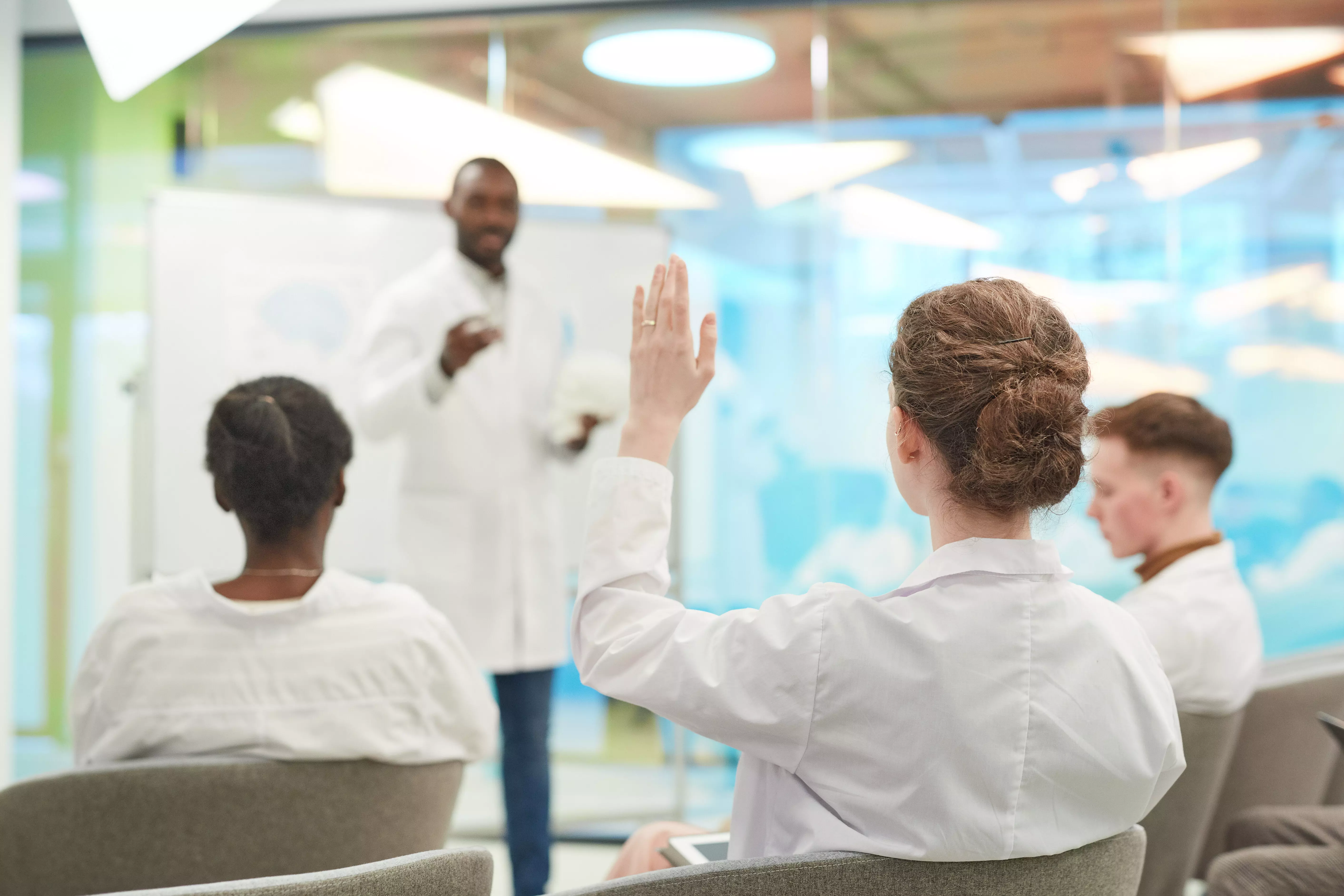 A young medical student listens to a lecture