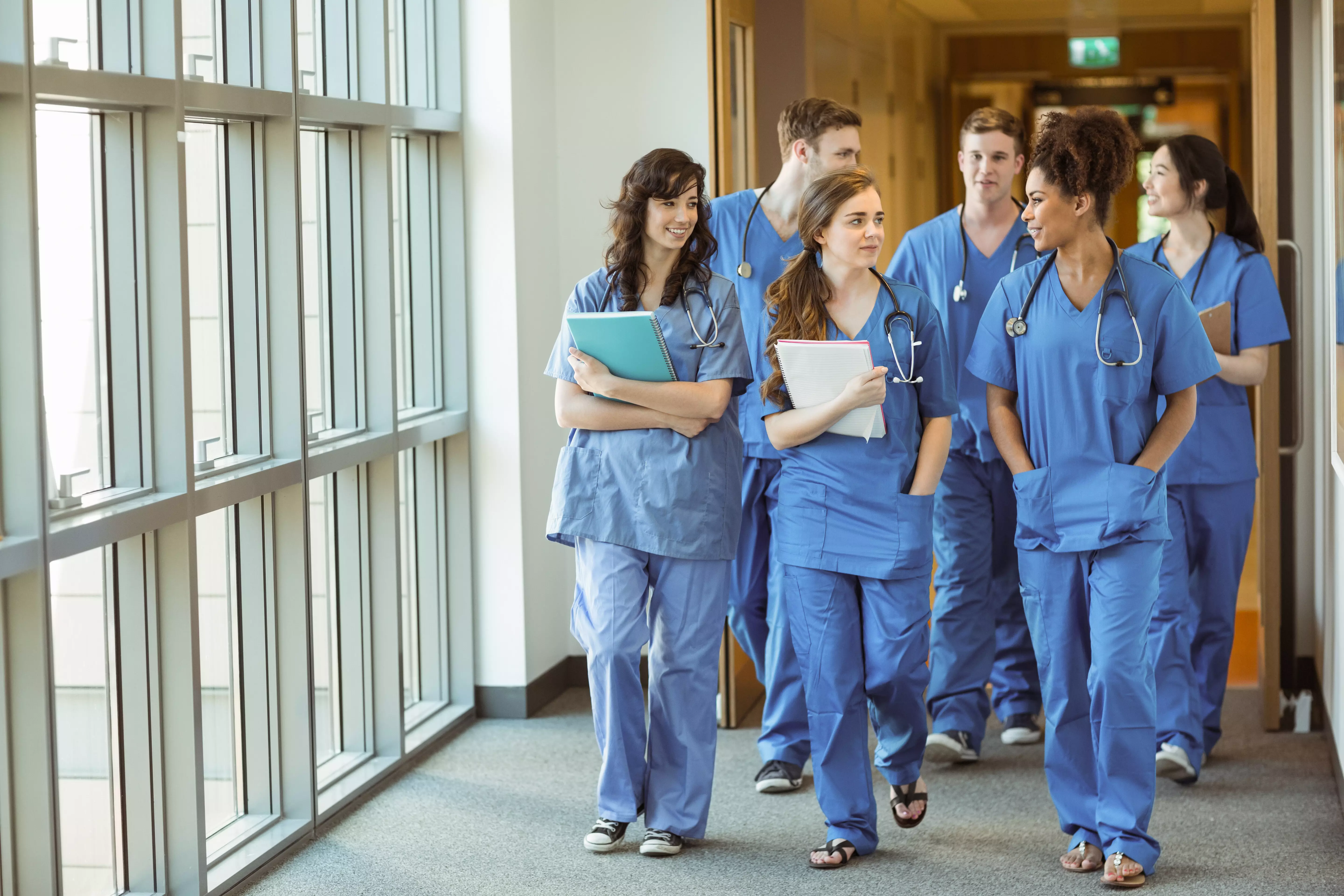 group of  young medical students are walking in the hallway of the university